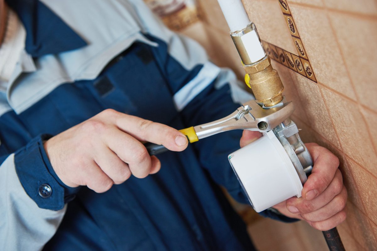 Plumber work. maintenance repairman worker installing gas meter counter